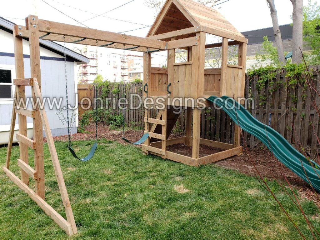 5'x5' Clubhouse with wooden roof, 4' Deck height, Standard slide, Rock wall entry, 8' Monkey bars with dual ladders & 2 Standard swings