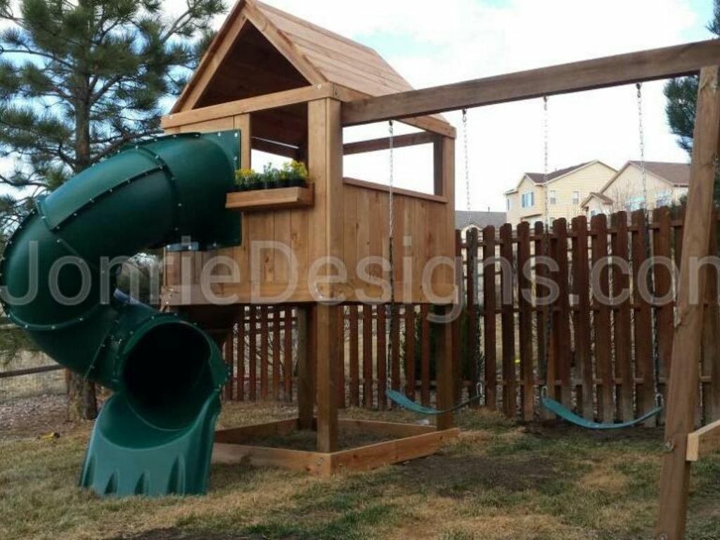 5'x5' Clubhouse with wooden roof, 4' Deck height, 5' Enclosed spiral slide, Rock wall entry, 8' Swing beam with 2 Standard swings & Flower planter