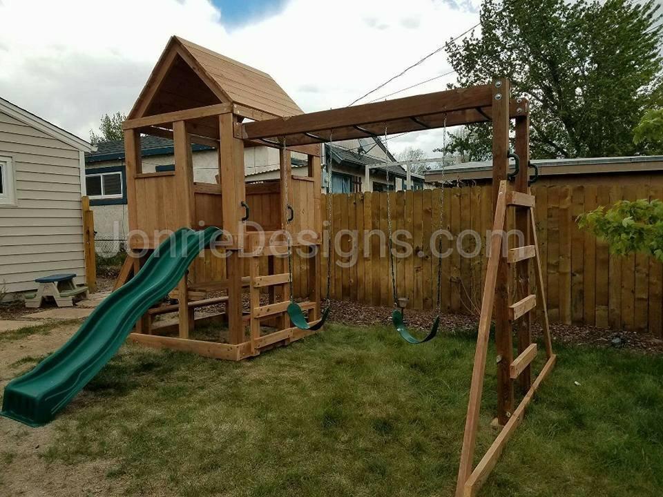 5'x5' Clubhouse with wooden roof, 4' Deck height, 4' Standard slide, Rock wall entry, Picnic Table, 8' Monkey bars with dual ladders & 2 Standard swings