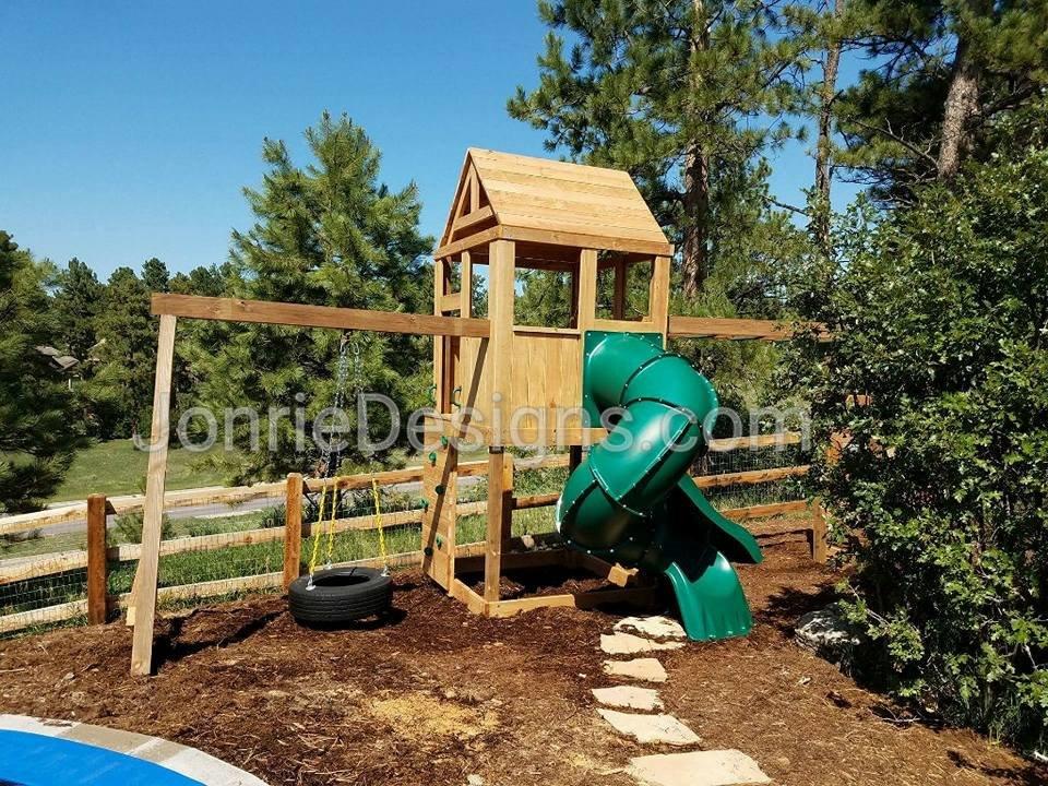 5'x5' Clubhouse with wooden roof, 5' Deck height, 5' Enclosed spiral slide, 5' Standard slide, 8' Monkey bars with dual ladders, Vertical rock entry, 8' Swing beam with Swivel Tire Swing