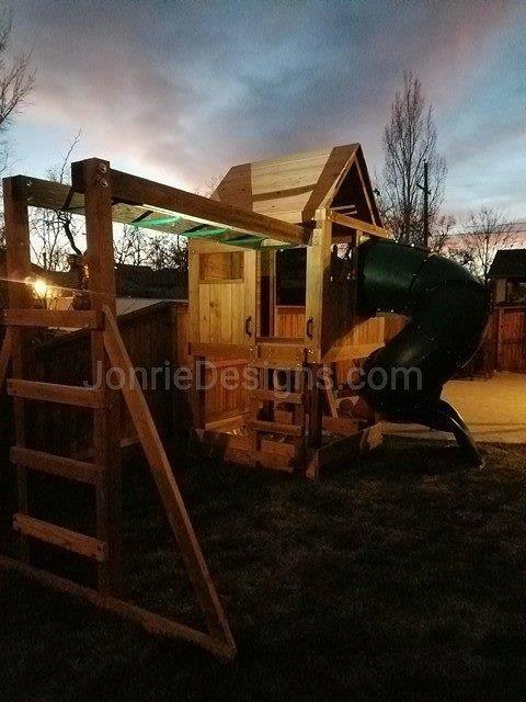 5'x5' Clubhouse with wooden roof, 4' Deck height, Rock wall entry, 5' Enclosed spiral slide, Sandbox framed & 8' Monkey bars with dual ladders