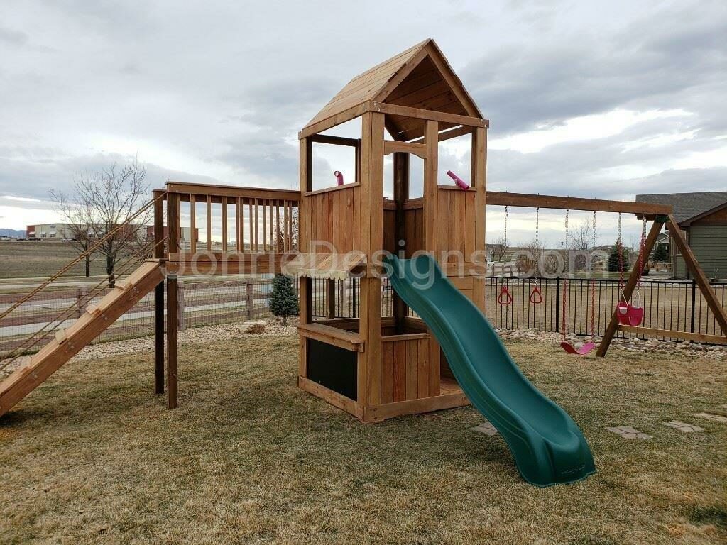 5'x5' Clubhouse with wooden roof, 5' Deck height, 2'x8' Bridge with Ramp, 5' Standard slide, Enclosed bottom with floor, Lemonade stand, 12' Swing beam with pink bucket swing, swing, rings, telescope & periscope